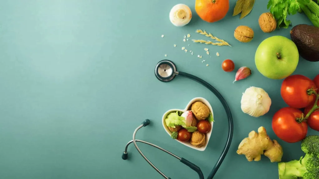Pregancy Nutrition Tips. A stethoscope and heart-shaped bowl filled with vegetables and nuts are surrounded by fresh produce on a blue background.